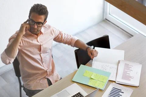 Man, phone call and documents in office for business growth, data analysis .. Stock Photos