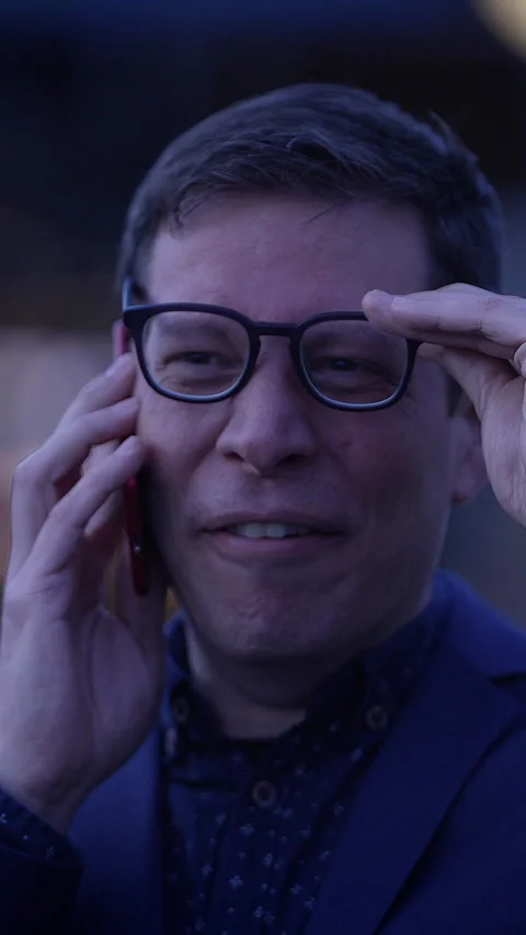 A man is on the phone displaying an expression of deep distress and concern Stock Footage 288619793