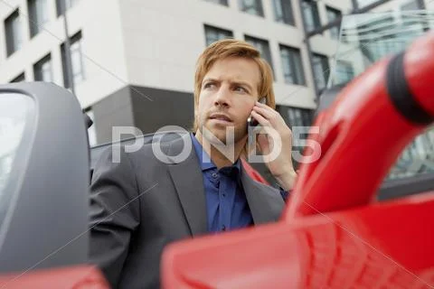 Man On Phone In His Electric Sports Car