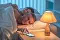 The man with a phone lay near sleeping woman Photo