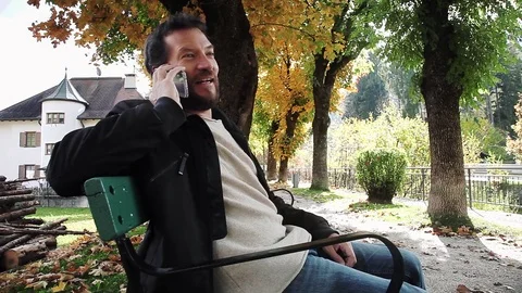 Man on the phone in the mountain happy talking with girlfriend wide shot pr.. Stock Footage 73734848