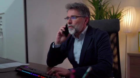 A man is on the phone smiling while working in the office Stock-Footage 268328005