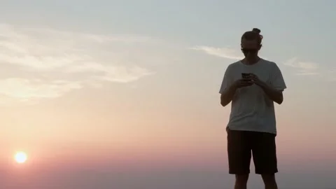 Man with phone at sunset. Stock Footage 198847887
