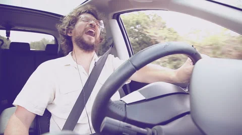 Man on the phone while driving car laughing Stock Footage 47834740