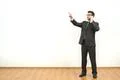 The man phones and gestures on the white wall background Photo