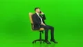The man phones on the office chair on the green background 4k or 4k+ Resolution