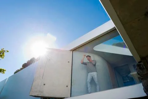 Man phoning behind window Stock Photos