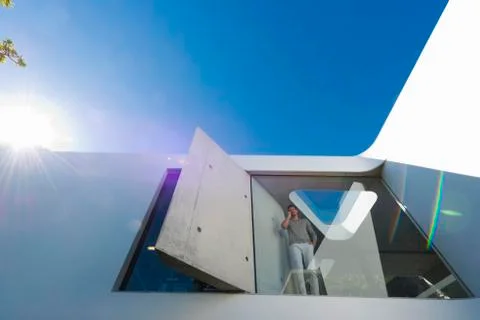 Man phoning behind window Stock Photos