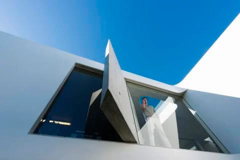 Man phoning behind window Stock Photos