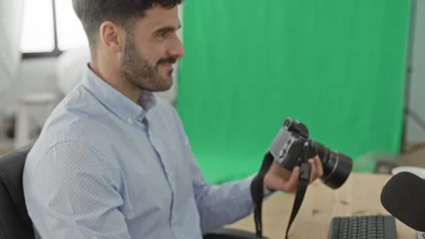 Man photographer holding camera with left hand on mouse and looking at lens.. Stock Footage 337373482