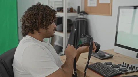 Man photographer holds camera with both hands while right hand rests on key.. Stock Footage 337403046