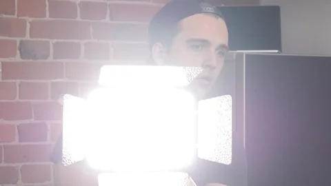 Man Photographer preparing Light system in Photo Studio Stock Footage 89671904