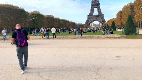 Man photographing the Eiffel Tower with his phone during Autumn in Paris, France Stock Footage 221769496
