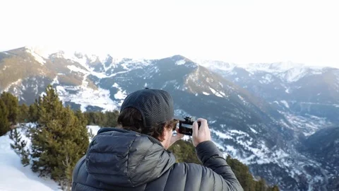 Man photographing high mountain Stock Footage 102851695