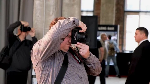 A man photographs on a camera Stock Footage 104899630