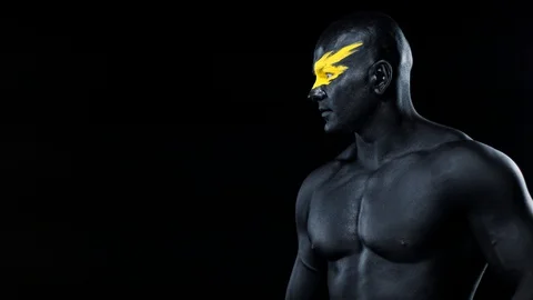 Man pick on copy space. Bodybuilder athlete with yellow face art and black body Stock Footage 128890577