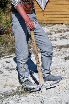 A man with a pickaxe is mining gold. Stock Photos