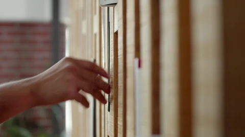 Man picking up and placing back a book on shelf. Stock Footage 64101540