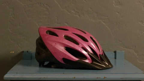 Man picking up bicycle helmet from table Stock Footage 107937601