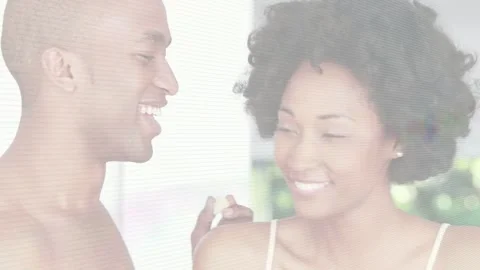 Man picking bite from bowl and feeding woman, sharing playful food moment at Stock Footage 332614378