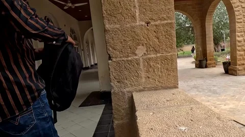 Man picking up black backpack from stone ledge and walking away Vidéo 343261360