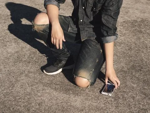 Man picking broken smartphone from floor Stock Photos