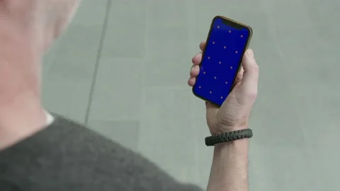 Man picking up calling smart phone iPhone blue green screen replacement Stock Footage 220422988