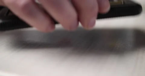 Man picking up cell phone that's face down close up on hand Video stock 234590094