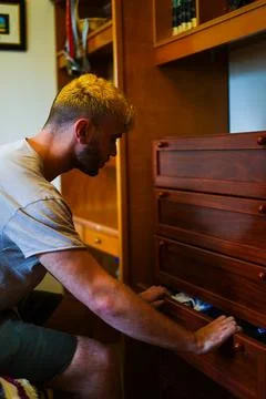 Man picking up clothes Stock Photos