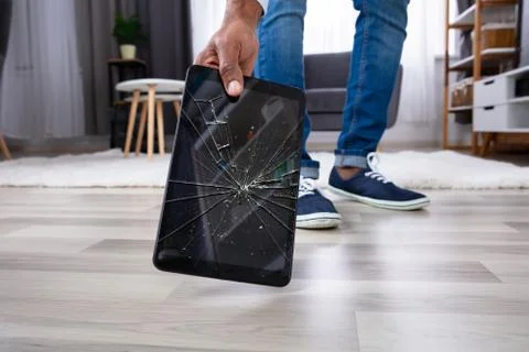 Man Picking Up Damaged Tablet Stock Photos