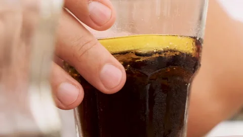 Man picking up drinking glass sparkling bubbles soda coke cola drink with lemon Stock Footage 218591472