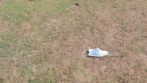 Man picking up a face mask in the forest Stock Footage 137162108