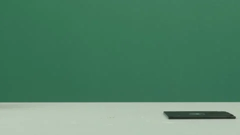 Man Picking Up a Floppy Disk from White Table with Green Screen Background Vídeos de archivo 344677135