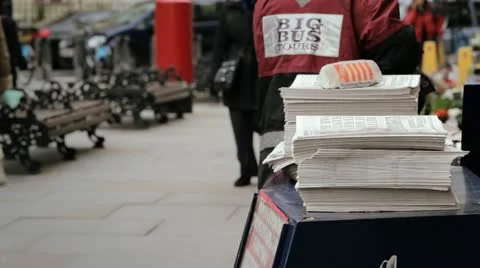 Man picking up a free newspaper in front of a tube station Vídeo Stock 21049636