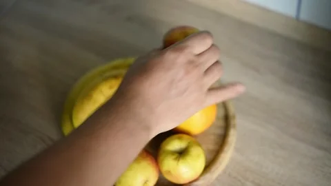 Man picking fresh bananas from fruit platter close up Stock Footage 340078020