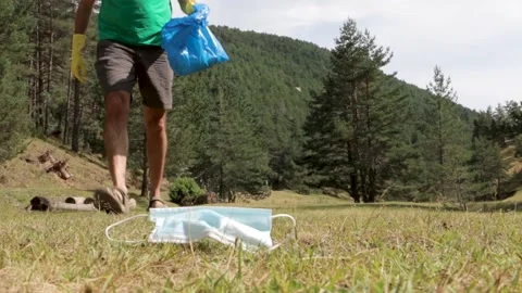 Man picking up garbage in the forest Stock Footage 137160907