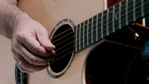 Man picking guitar strings Video stock 130790376