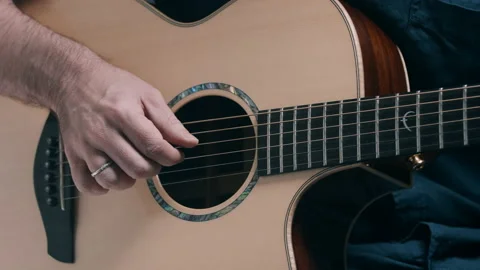 Man picking guitar strings Stock Footage 130791210