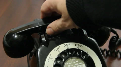 Man picking up handset on old rotary dial UK telephone close up Stock Footage 46284425