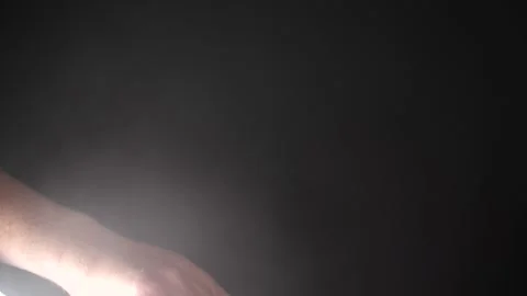 Man picking up headphones in slow motion close up isolated on black smoke Stock Footage 205535875