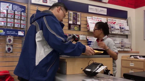 A man picking up his parcel at post office Stock Footage 275890431