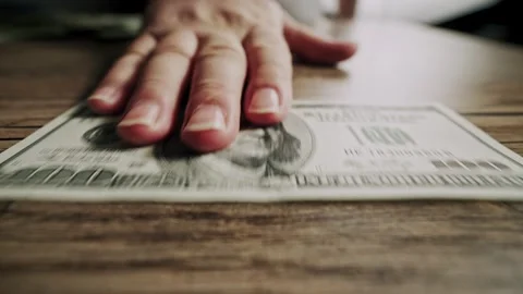 Man Picking Up One Hundred Dollar Banknote from Wooden Table 스톡 동영상 340857204