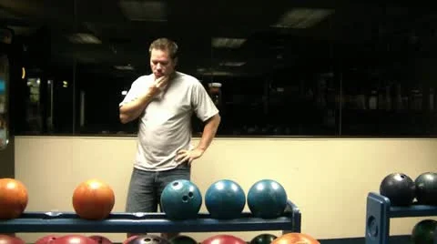 Man Picking Out Bowling Ball Stock Footage 12610202