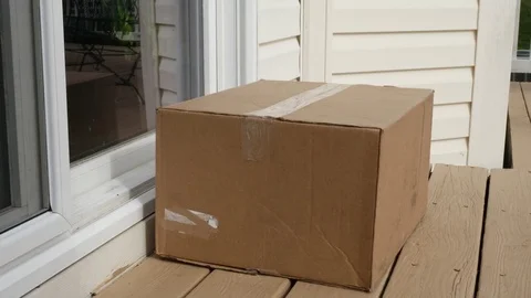 Man Picking Up Package Box Delivered By Post Office Sliding Glass Door Video stock 80798681