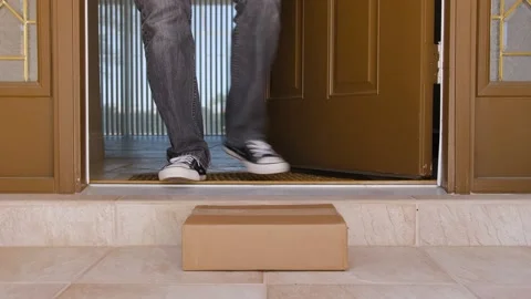 Man picking up a package delivery delivered to the doorstep Stock Footage 150967827