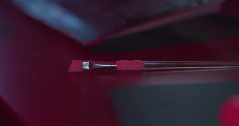 Man picking up paintbrush from desk table Stock Footage 249507480