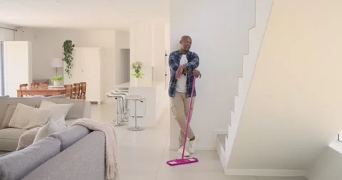 Man picking up pink mop and spraying floor, mopping tiles for home cleaning, Stock Footage 342929366