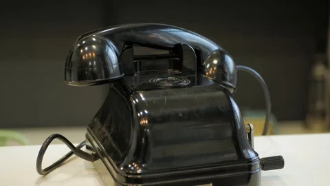 A man picking up the receiver and is trying to call on a retro telepho Stock Footage 121120828