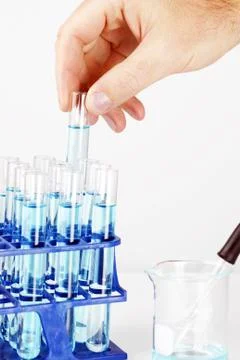 Man picking up sample in test tube Stock Photos