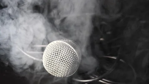 Man picking up vocal microphone then dropping in slow motion through smoke Stock Footage 204062863